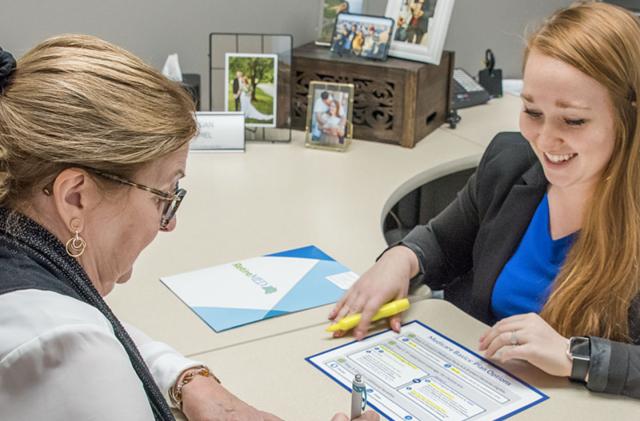 Woman signing RetireMed contract